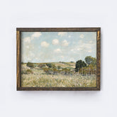 Framed painting of a landscape with a field, trees, and sky on a white background.