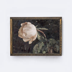 Framed artwork of a white flower with green leaves on a white background
