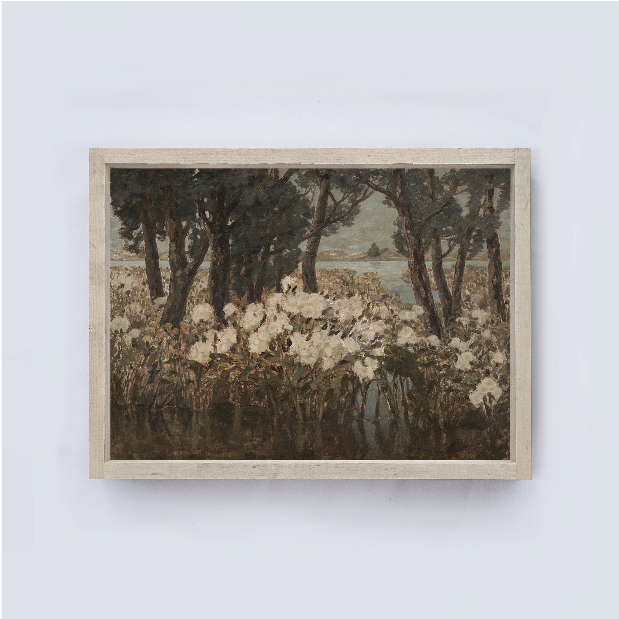 Framed artwork of a landscape with trees and flowers on a white wall