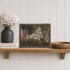 Wooden shelf with a framed artwork, vase with flowers, and wooden bowl against a light gray wall.