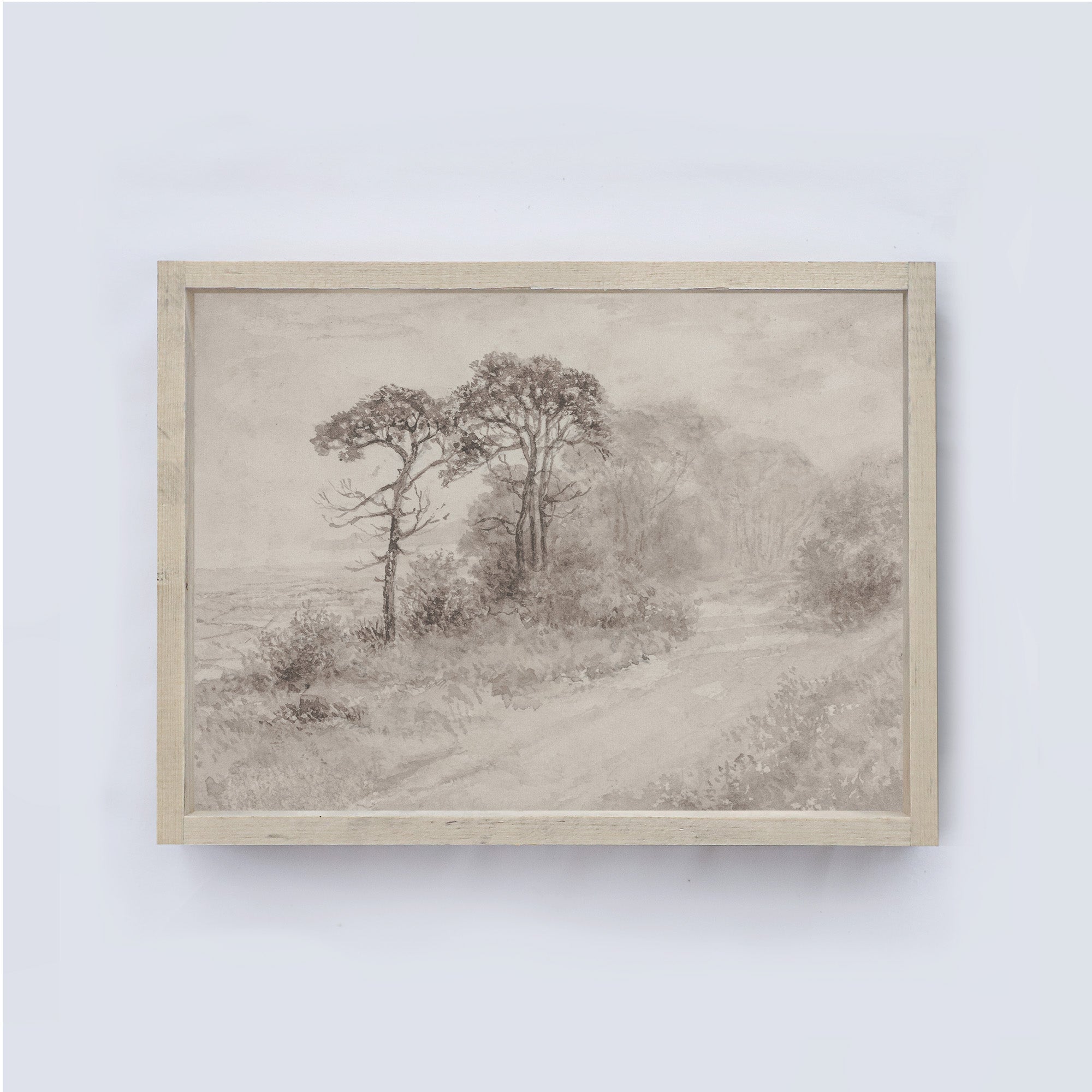 Framed artwork of a landscape with trees and a path on a light gray background