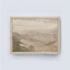 Framed soft mountain landscape painting on a white wall framed in a soft off white coloured wood frame.