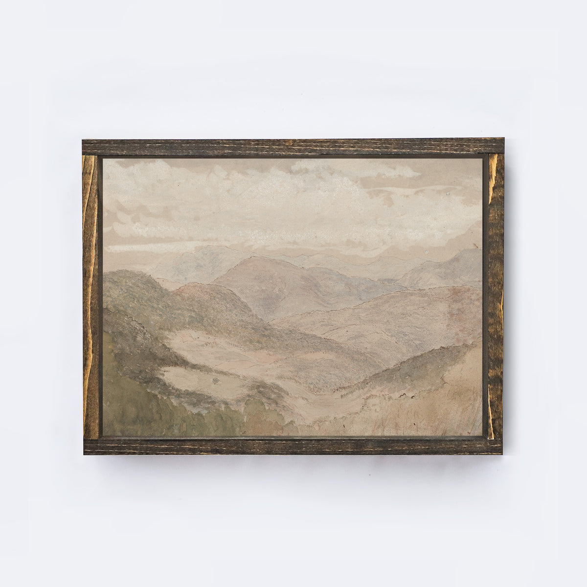 Framed soft mountain landscape painting on a white wall framed in an espresso coloured wood frame.